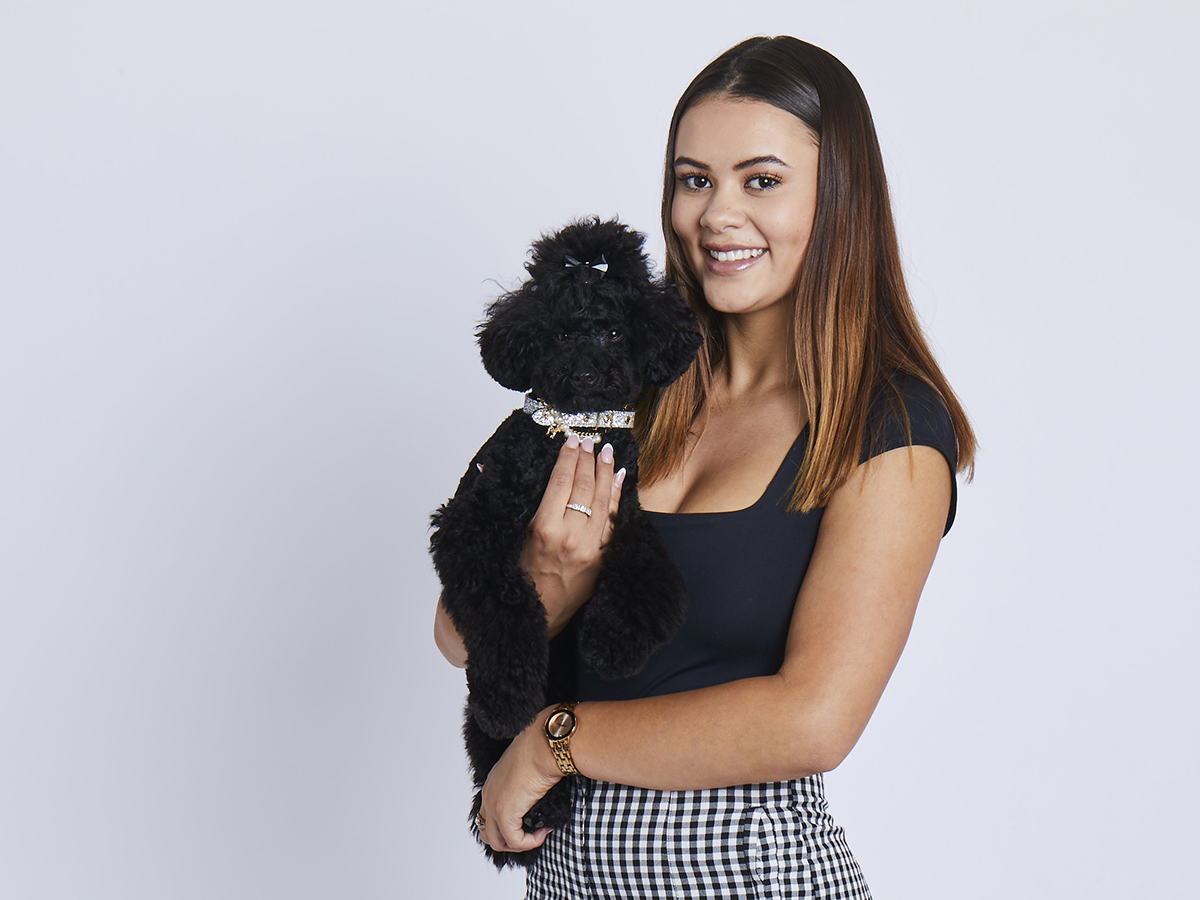 Jasmine Bates holding Gabana, her toy poodle